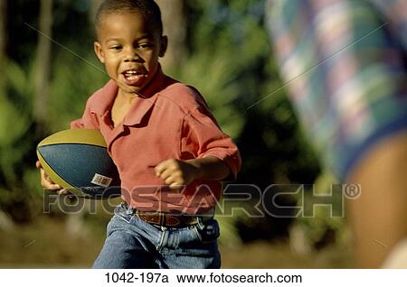 people, running, playing, ball, football, boy, outdoors View Large Photo Image Stock Image - people, running, playing, ball, football, boy, outdoors. Fotosearch