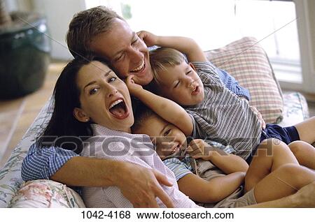 people, sitting, couch, sofa, family, squeezing, tickling View Large Photo Image Stock Photo - people, sitting, couch, sofa, family, squeezing, tickling. Fotosearch