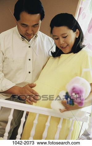 people, smiling, Asian, couple, stuffed animal, crib, smile View Large Photo Image Stock Image - people, smiling, Asian, couple, stuffed animal, crib, smile. Fotosearch