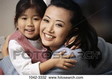 Stock Image - people, smiling, Asian, mother, happy, hugging. Fotosearch