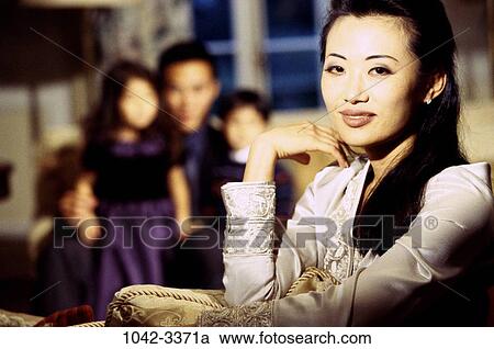 Stock Image - people, smiling, Asian, pillow, sitting, mother, holding. Fotosearch