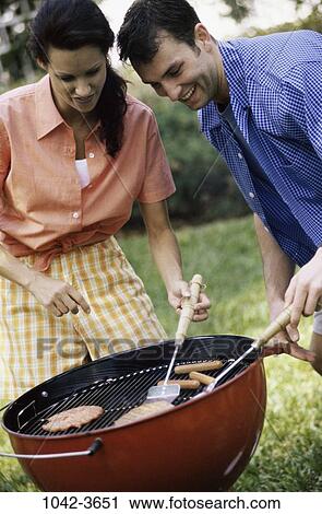 people, smiling, couple, cooking, hamburger, picnic, outdoors View Large Photo Image Stock Image - people, smiling, couple, cooking, hamburger, picnic, outdoors. Fotosearch