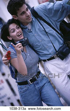 people, smiling, couple, Hispanic, pointing, outdoors, hugging View Large Photo Image Stock Image - people, smiling, couple, Hispanic, pointing, outdoors, hugging. Fotosearch