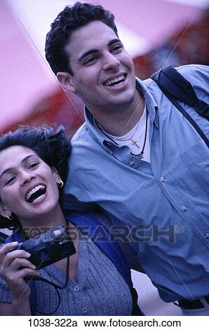 Stock Image - people, smiling, couple, Hispanic, laughing, outdoors, joyous. Fotosearch