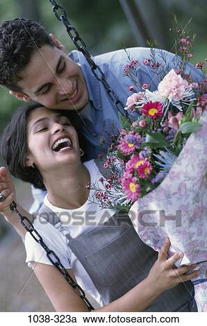 people, smiling, couple, Hispanic, laughing, flowers, swing View Large Photo Image Stock Image - people, smiling, couple, Hispanic, laughing, flowers, swing. Fotosearch