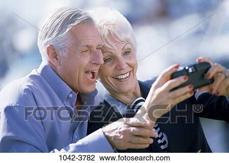 Stock Image - people, smiling, couple, senior, take, outdoors, tourism. Fotosearch