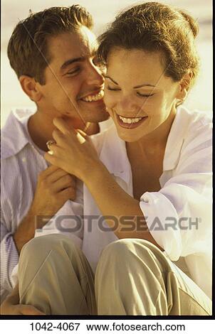 people, smiling, couple, sitting, flirting, romantic, whispering View Large Photo Image Stock Photo - people, smiling, couple, sitting, flirting, romantic, whispering. Fotosearch