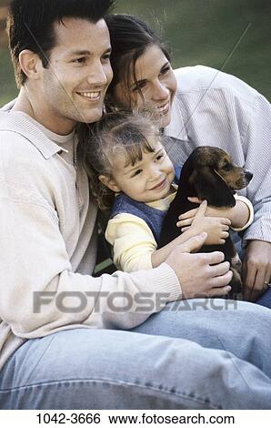 people, smiling, dog, puppy, holding, outdoors, hugging View Large Photo Image Stock Photograph - people, smiling, dog, puppy, holding, outdoors, hugging. Fotosearch