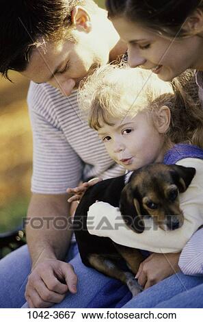 Stock Photo - people, smiling, dog, puppy, pet, holding, outdoors. Fotosearch