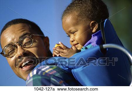people, smiling, eyeglasses, baby, happy, outdoors, family View Large Photo Image Stock Image - people, smiling, eyeglasses, baby, happy, outdoors, family. Fotosearch