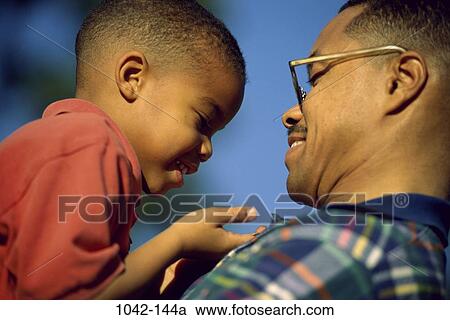 people, smiling, eyeglasses, outdoors, nurturing, family View Large Photo Image Stock Image - people, smiling, eyeglasses, outdoors, nurturing, family. Fotosearch