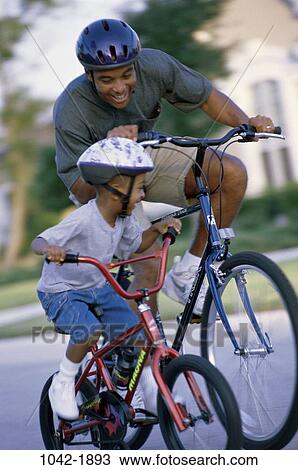 people, smiling, guiding, racing, outdoors, nurturing, bicycles View Large Photo Image Stock Image - people, smiling, guiding, racing, outdoors, nurturing, bicycles. Fotosearch