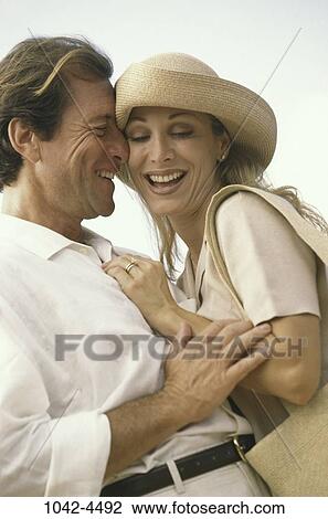 people, smiling, hat, couple, happy, laughing, outdoors View Large Photo Image Stock Image - people, smiling, hat, couple, happy, laughing, outdoors. Fotosearch