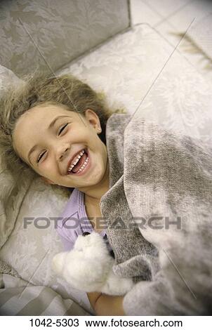 people, smiling, laughing, couch, sofa, stuffed animal View Large Photo Image Stock Image - people, smiling, laughing, couch, sofa, stuffed animal. Fotosearch