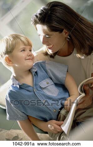 Stock Image - people, smiling, mother, happy, book, holding, smile. Fotosearch