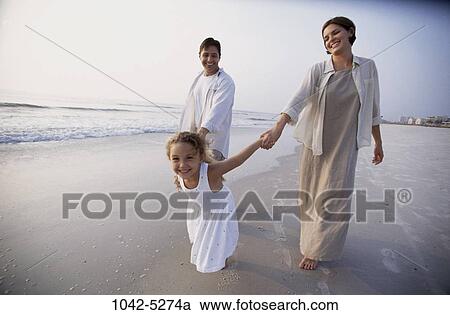 Stock Image - people, smiling, walking, beach, holding, anxious, pulling. Fotosearch