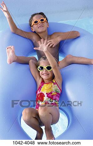 people, swim, floating, pool, playing, swimming, sunglasses View Large Photo Image Stock Photo - people, swim, floating, pool, playing, swimming, sunglasses. Fotosearch