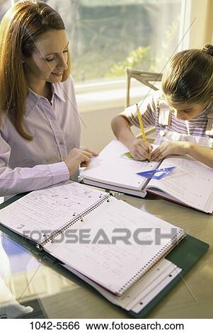 people, table, window, mother, reading, homework, notebook View Large Photo Image Stock Photograph - people, table, window, mother, reading, homework, notebook. Fotosearch