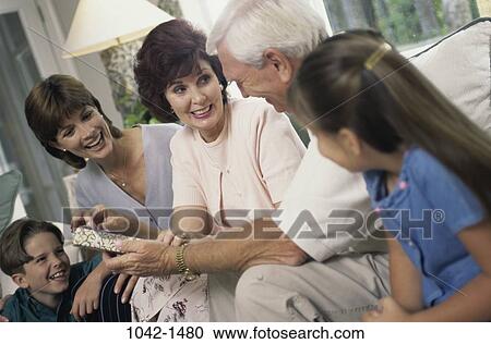 Stock Image - people, three, family, gift, present, generations. Fotosearch