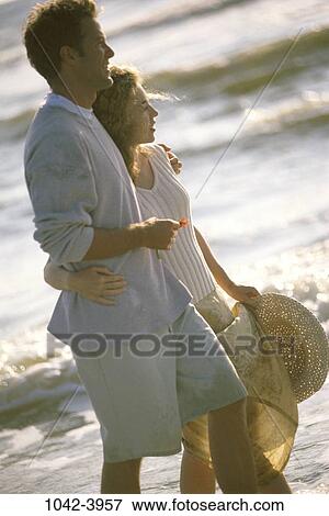 people, wading, water, hat, walking, couple, beach View Large Photo Image Stock Photo - people, wading, water, hat, walking, couple, beach. Fotosearch