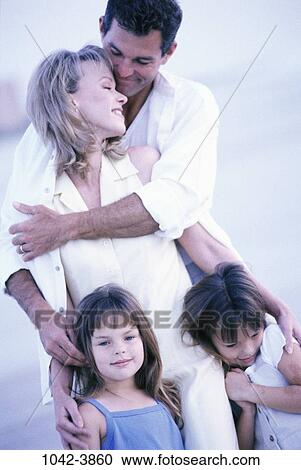 Stock Image - people, walking, beach, hugging, family, embracing, affection. Fotosearch