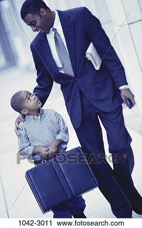 Stock Image - people, walking, briefcase, suit, outdoors, nurturing, carrying. Fotosearch