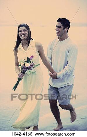 people, walking, couple, beach, laughing, flowers, romantic View Large Photo Image Stock Photograph - people, walking, couple, beach, laughing, flowers, romantic. Fotosearch