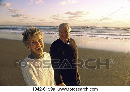 people, walking, couple, senior, sunset, beach, laughing View Large Photo Image Stock Image - people, walking, couple, senior, sunset, beach, laughing. Fotosearch