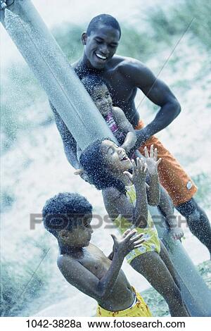 people, water, beach, laughing, splash, family, surprise View Large Photo Image Stock Image - people, water, beach, laughing, splash, family, surprise. Fotosearch