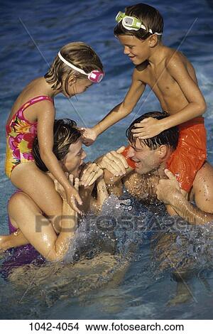 people, water, pool, playing, splash, holding, playful View Large Photo Image Picture - people, water, pool, playing, splash, holding, playful. Fotosearch