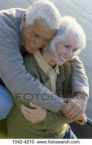 Stock Image - people, water, smiling, couple, senior, encircling, outdoors. Fotosearch