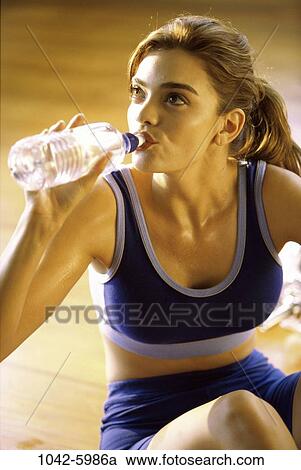 people, water, woman, bottle, drinking, resting, water bottle View Large Photo Image Stock Image - people, water, woman, bottle, drinking, resting, water bottle. Fotosearch