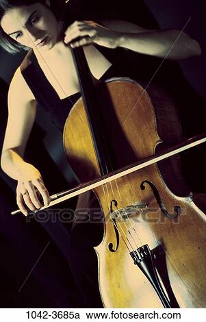 Stock Image - people, woman, playing, concentration, music, concentrating, classical. Fotosearch