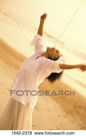 people, woman, raised, beach, individuality, arms, reaching View Large Photo Image Stock Photo - people, woman, raised, beach, individuality, arms, reaching. Fotosearch