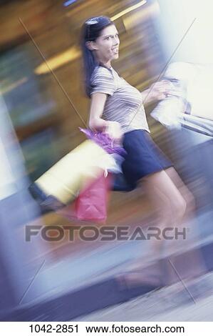 people, woman, rush, motion, outdoors, speed, shopping View Large Photo Image Stock Image - people, woman, rush, motion, outdoors, speed, shopping. Fotosearch