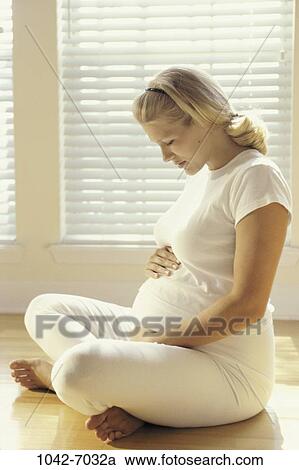 people, woman, sitting, floor, stomach, holding, nurturing View Large Photo Image Stock Image - people, woman, sitting, floor, stomach, holding, nurturing. Fotosearch