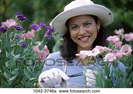 people, woman, smiling, hat, Hispanic, flowers, gardening View Large Photo Image Stock Image - people, woman, smiling, hat, Hispanic, flowers, gardening. Fotosearch
