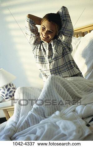 people, woman, smiling, morning, sitting, bed, stretching View Large Photo Image Stock Photo - people, woman, smiling, morning, sitting, bed, stretching. Fotosearch