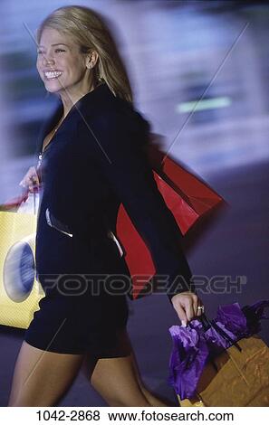 people, woman, smiling, rush, motion, outdoors, shopping View Large Photo Image Stock Photo - people, woman, smiling, rush, motion, outdoors, shopping. Fotosearch