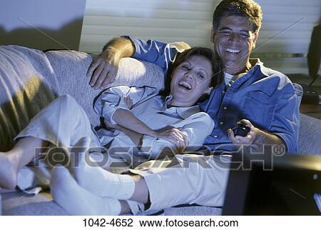 relaxed, people, couple, watch, laughing, entertainment, Middle-aged View Large Photo Image Stock Image - relaxed, people, couple, watch, laughing, entertainment, Middle-aged. Fotosearch