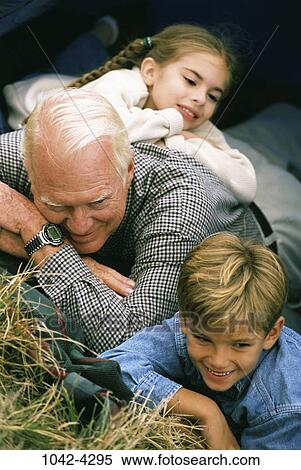 Stock Photography - relaxed, people, smiling, hay, leaning, outdoors, relaxing. Fotosearch