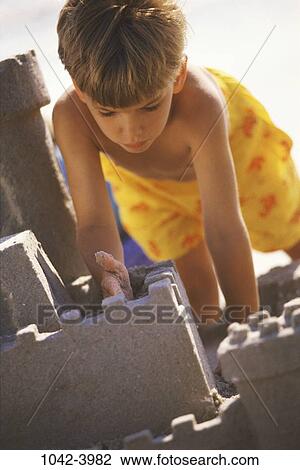 sand, people, building, playing, beach, boy, leaning View Large Photo Image Stock Image - sand, people, building, playing, beach, boy, leaning. Fotosearch