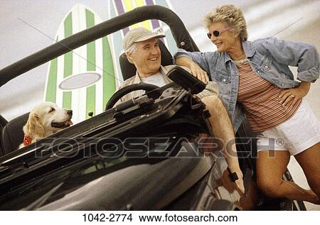 Picture - sand, people, smiling, dog, couple, senior, beach. Fotosearch
