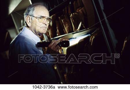 Stock Image - senior, secretive, curious, vice, searching, flashlight. Fotosearch