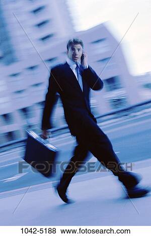 telephone, walking, briefcase, talking, rush, conversation, phone View Large Photo Image Stock Photo - telephone, walking, briefcase, talking, rush, conversation, phone. Fotosearch