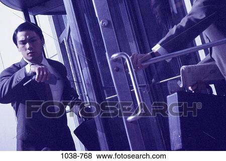 Stock Photo - time, Asian, door, watch, business. Fotosearch