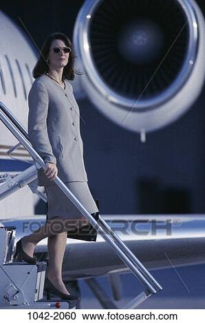 Stock Image - transportation, woman, outdoors, business, sunglasses, Middle-aged, airplane. Fotosearch