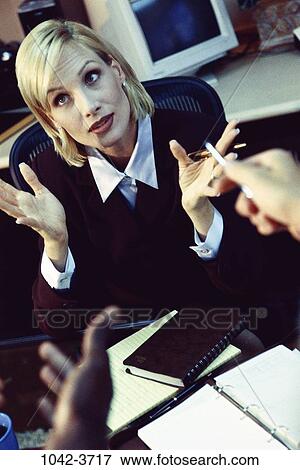 Stock Photo - woman, overwhelmed, stress, defensive, business, chaotic, Middle-aged. Fotosearch