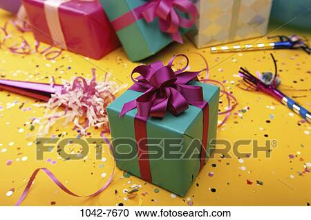 Stock Image - celebration, wrapped, birthday, festive, confetti, streamers, gifts. Fotosearch