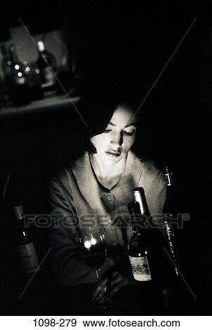 Stock Photo - dark, people, woman, choices, depression, bottles, challenges. Fotosearch